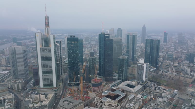 Building new skyscraper. Construction site with tower cranes near group of high rise office buildings. Frankfurt am Main, Germany