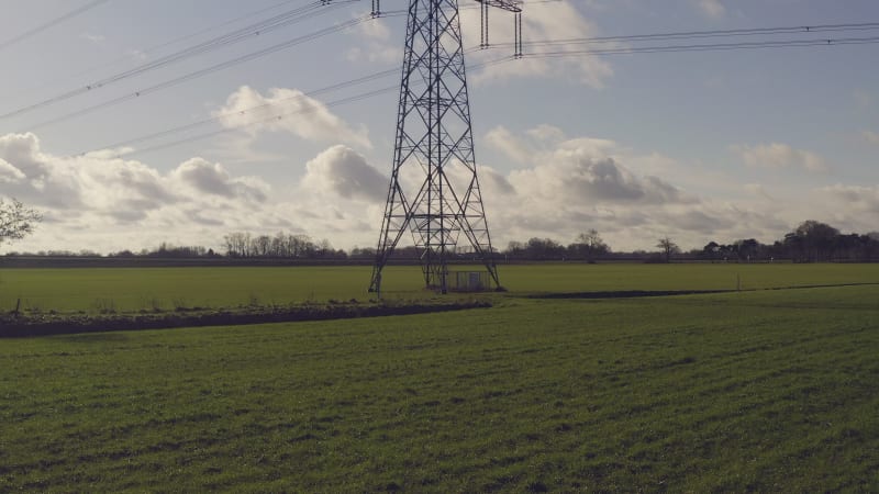 A shot of a power line pole from low to high