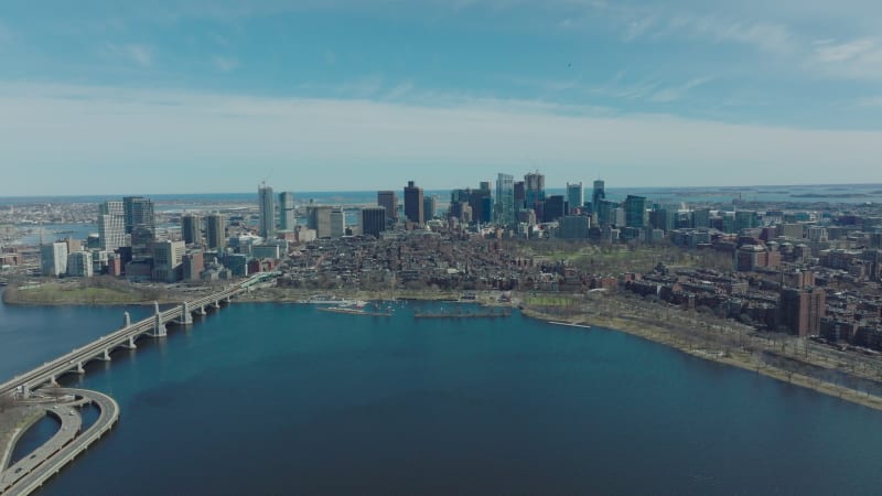 Aerial panoramic footage of city with group of downtown skyscrapers. Longfellow Bridge over Charles river. Boston, USA