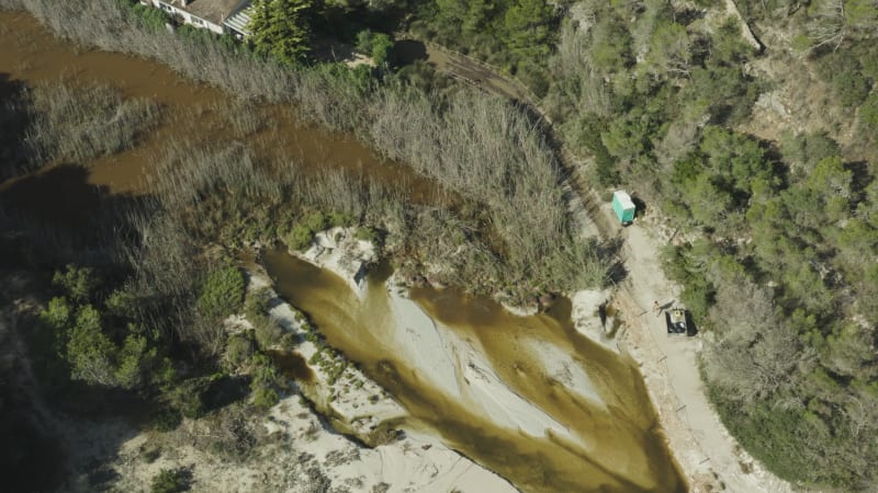 Pollution on Mallorca Beach, with a person going into a dixie toilet