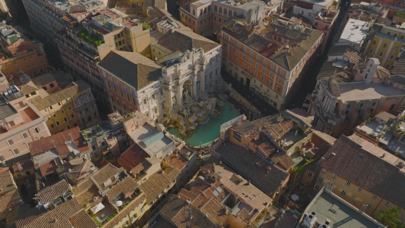 High angle view of famous Trevi Fountain with sculptures and turquoise water. Aerial view of tourist sight. Rome, Italy