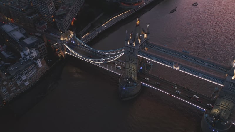 Amazing evening aerial view of Tower Bridge. Historic landmark over Thames river after sunset. Traffic in rush hour. London, UK