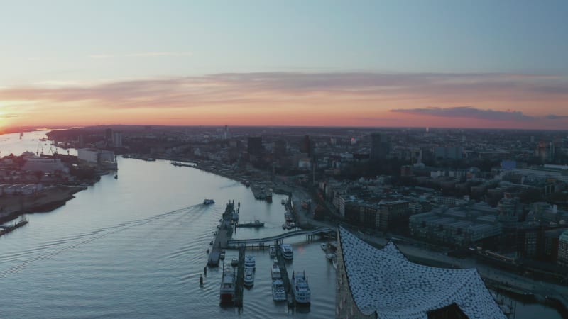 Aerial view of modern buildings in Hamburg city center on the banks of Elbe river during sunset