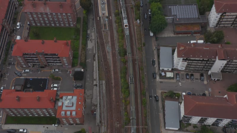 High angle view of passenger train units on track in city. Driving through train station. London, UK