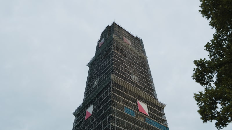 An aerial perspective captures the maintenance and restoration scaffolding the majestic Dom tower in the historic city of Utrecht.