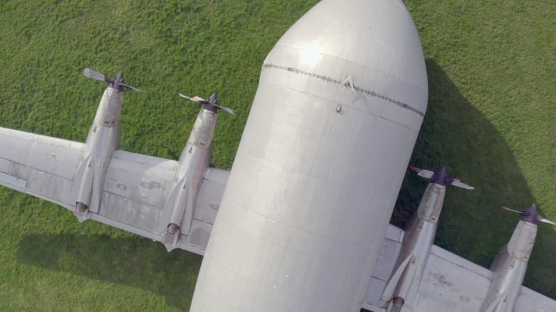 Old Cargo Plane at an Airfield on the Grass Bird's Eye View