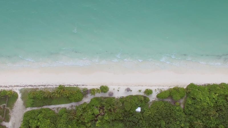 Aerial view above of beach with transparent water.