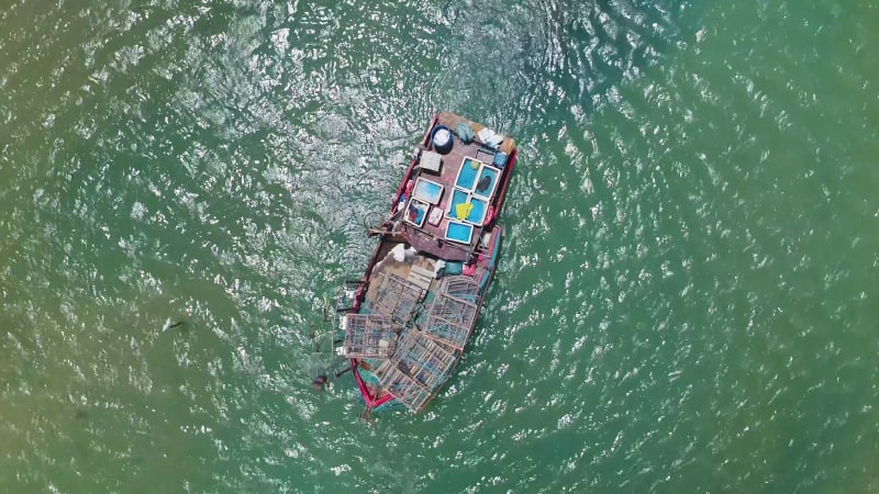 Aerial view of fishing boat navigating on transparent river, Cascalve.