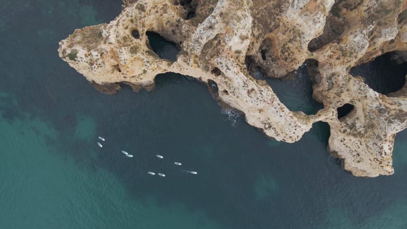 Aerial view of people doing kayak along the coast, Algarve, Portugal.