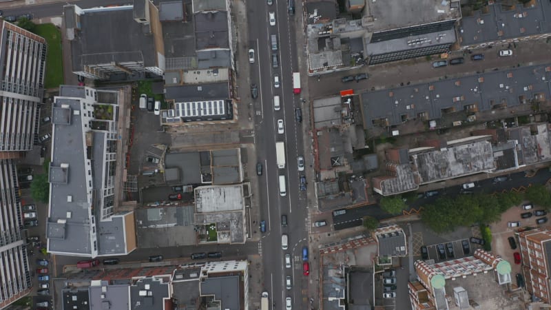 Aerial birds eye overhead top down panning view of long queue of cars standing in traffic jam in city street. London, UK