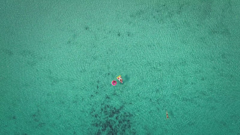 Aerial view of two young girls swimming and playing.