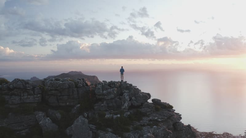 Aerial View of a Person on the peak watching the wave in Table Mountain Reserve.