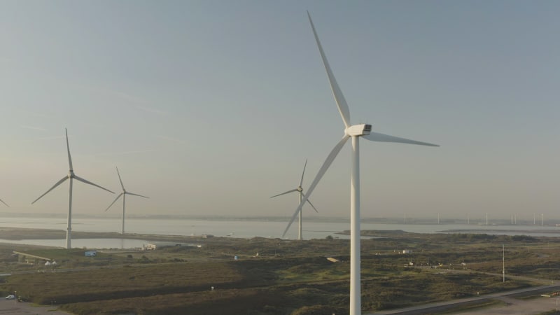 Aerial view of windmills spinning at sunrise in the Netherlands