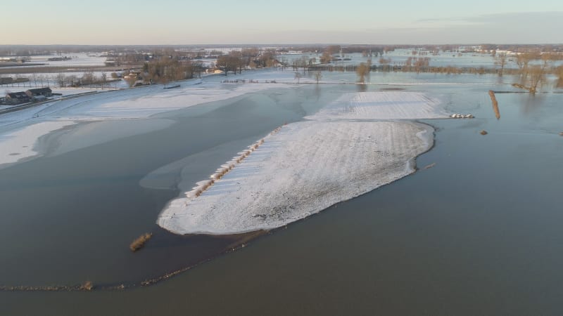 Aerial view of snow-covered island in flood plains of river IJssel, Netherlands.