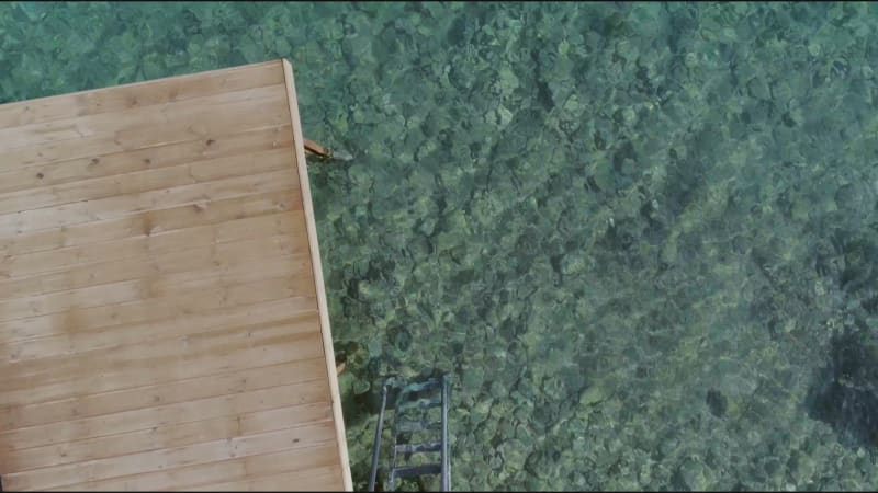 Aerial view of a wooden deck in the mediterranean sea.