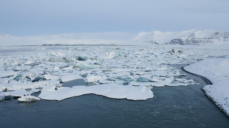 Flying towards Snowy Ice Floes on Iceland Lake Winter, Snow