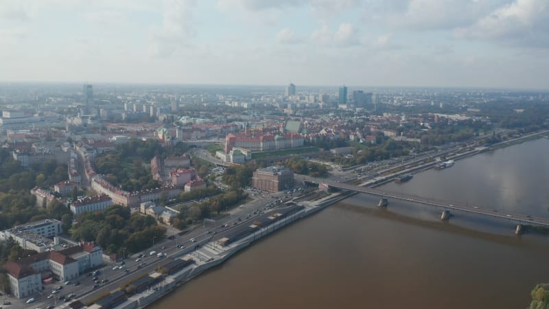 Aerial panoramic shot of heavy traffic on waterfront road. Historic buildings and Royal Castle. Warsaw, Poland