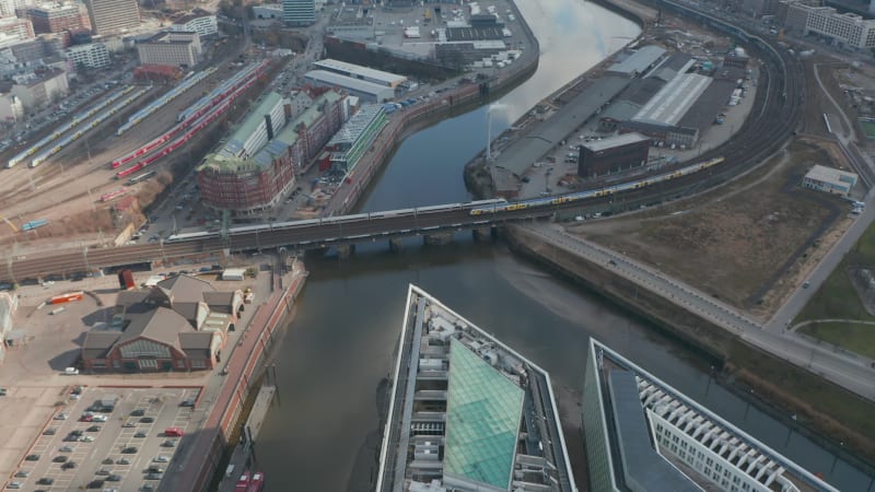 Aerial view of trains crossing Elbe river canal on a railway in Hamburg city center