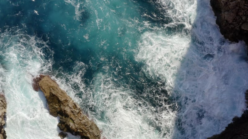 Birds View of beautiful Ocean Blue Water on Rock Coast crMavic 2 prohing on Tropical Island Mallorca, Spain Vacation, Travel, Sunny, Waves