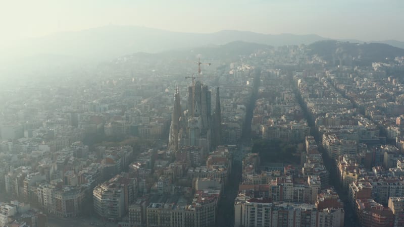 Towards La Sagrada Familia with Cranes in Beautiful City Sunny Haze over Barcelona, Spain