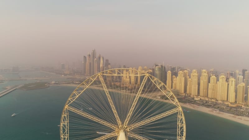 Aerial view passing by of the Ferris wheel under constructi.