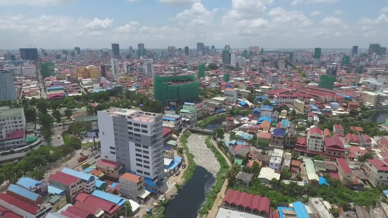 Aerial view of polluted river crossing city.