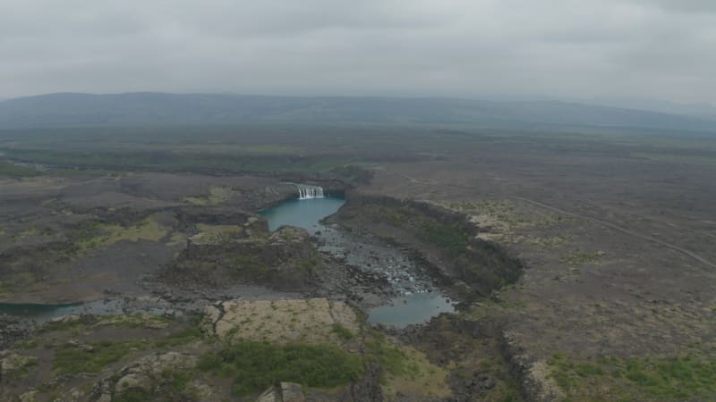 Aerial view of famous waterfall of Aldeyjarfoss situated in the northern part of the Sprengisandur Road in icelandic highlands. Drone view of stunning basalt and rocky countryside in north iceland