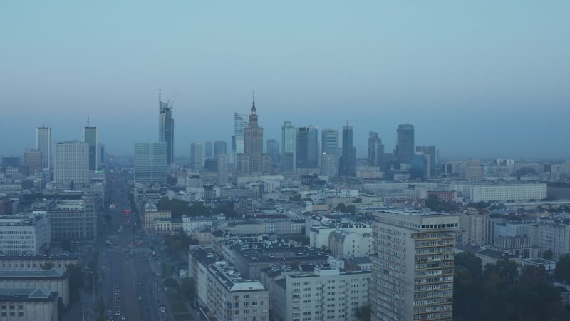 Rising aerial panoramic footage of city view group of tall modern office buildings. Blue toned morning view. Warsaw, Poland