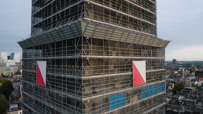 An aerial perspective captures the maintenance and restoration scaffolding the majestic Dom tower in the historic city of Utrecht.