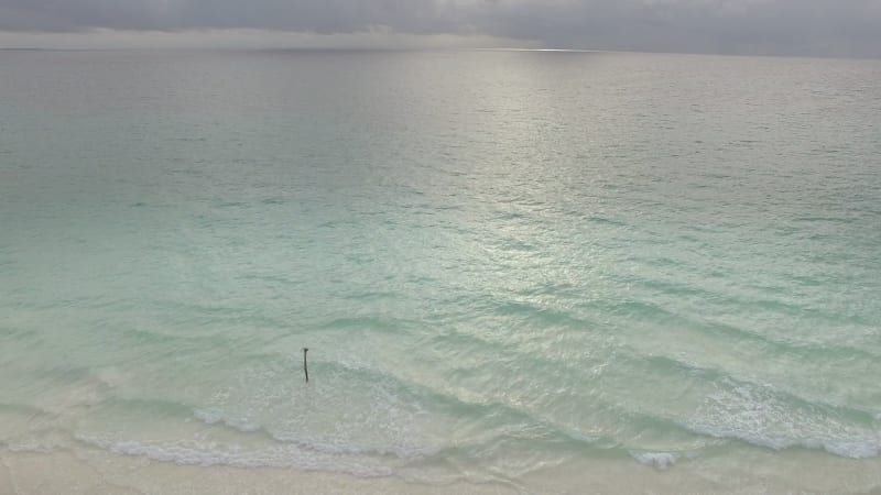 Aerial view above of beach with transparent water.