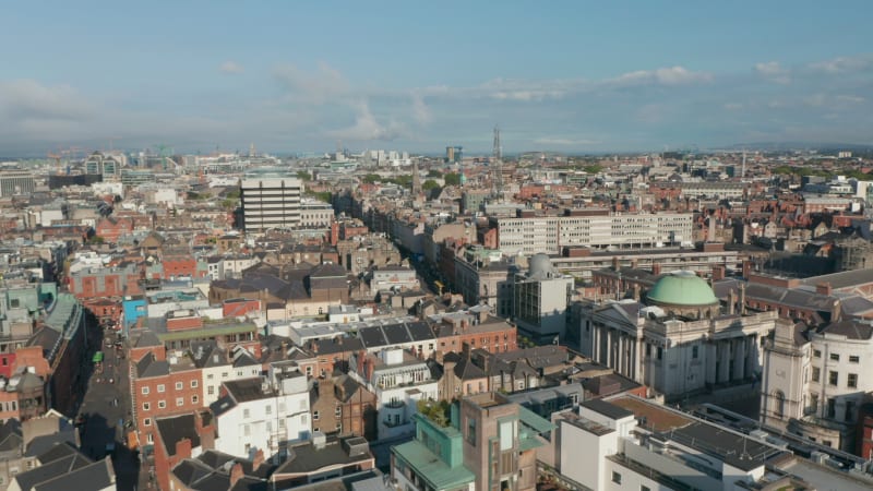 Aerial footage of town development. Fly above building roofs in city centre on sunny day. Dublin, Ireland