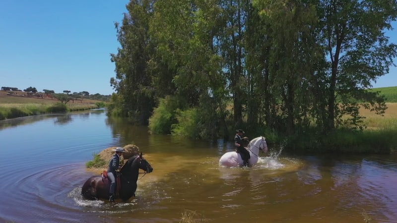 Aerial view of horse back riders on large ranch estate.