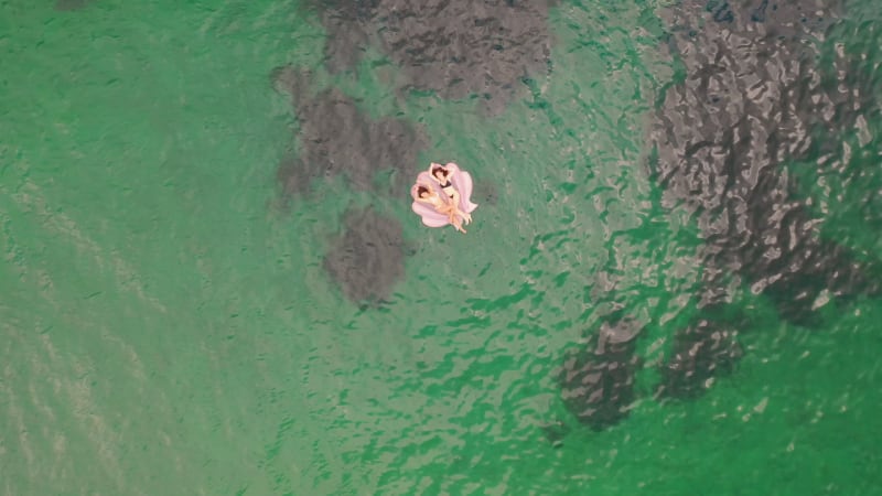 Aerial view of attractive girls with an inflatable at Gordons Bay.