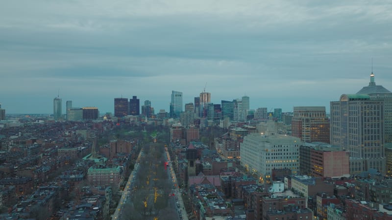 Slider of urban neighbourhood after sunset. Panoramic view of downtown skyscrapers in distance. Boston, USA