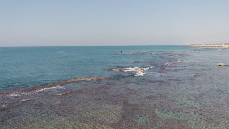 Aerial view of a man fishing in the sea, Acre, Israel.