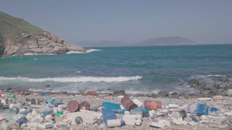 Beach covered in plastic and rubbish showing climate change issue in Hong Kong. Aerial drone view