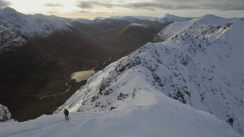 Mountain Climber Surveying a Ridge in the Sunny Afternoon