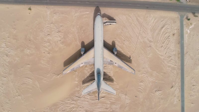 Aerial view above of museum airplane on desert landscape