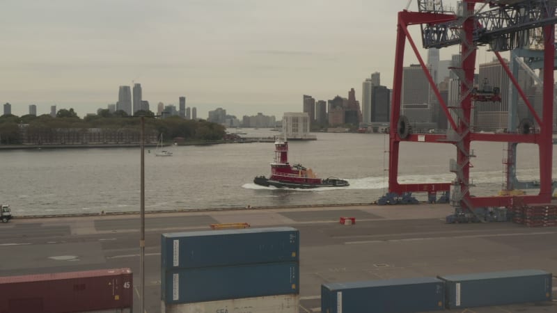 Red Ship,Boat passing by in New York City docks on cloudy day