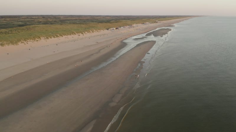 Birds eye view of people enjoying the sun next to the seashore