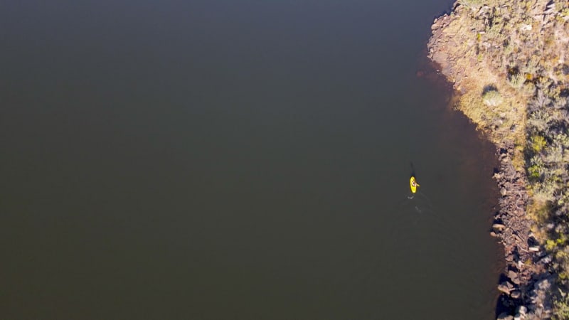 Aerial view woman on yellow kayak, Western Cape, South Africa.