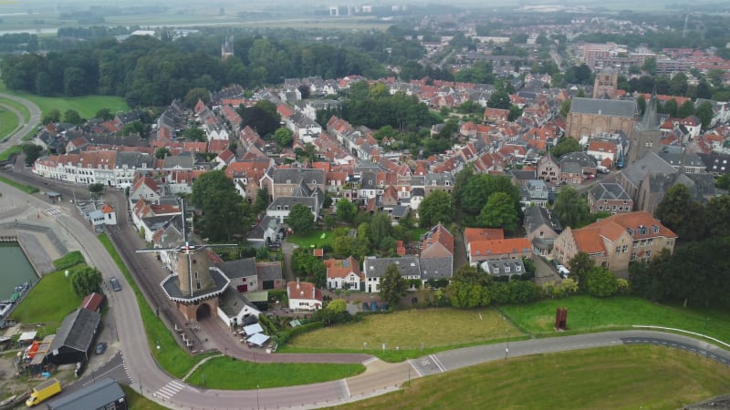 Drive-through windmill, church and houses in Wijk bij Duurstede town, the netherlands.