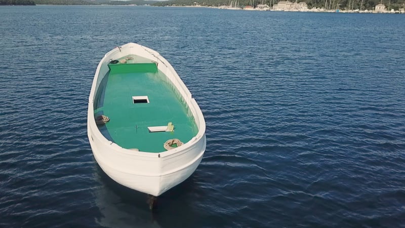 Aerial view of unfinished boat anchored alone at Adriatic sea.