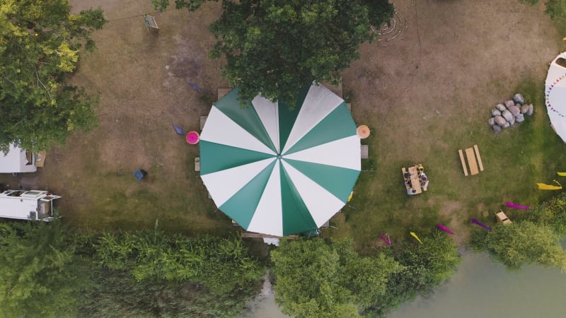 Descending top down shot of a festival tent with people along the side