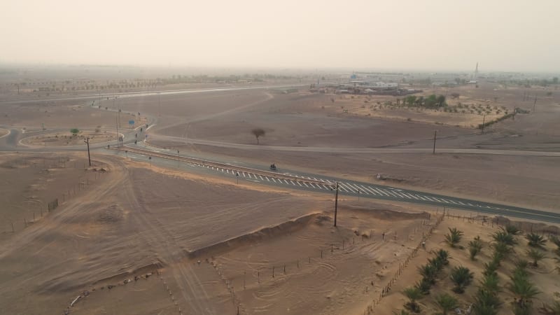 Aerial view of group practicing motocross on desert landscape.