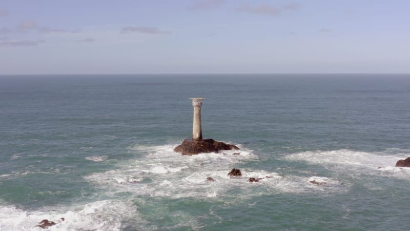 Isolated Lighthouse at Sea on a Rock During the Summer