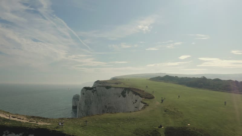 People walking on top of the Old Harry Rocks in England