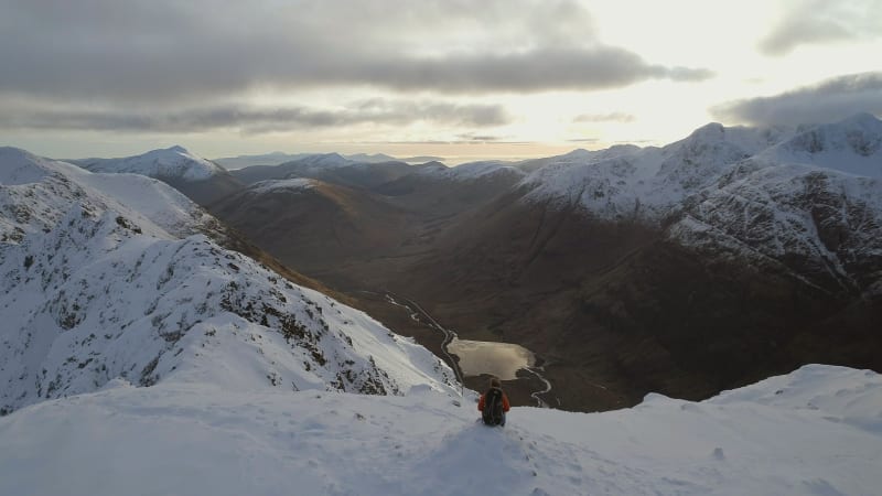 Mountaineer on the Summit of a Snowy Mountain