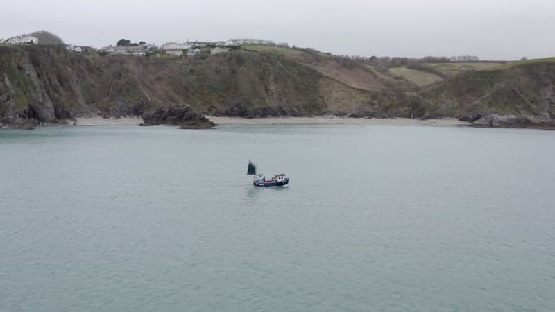 Fishing Boat Pulling Nets on a Grey Day Aerial Shot