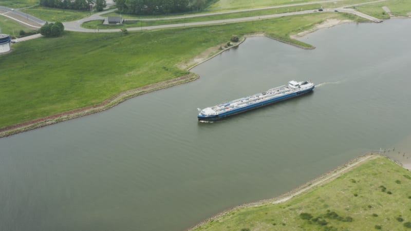 Cargo vessel sailing through Dutch river systems